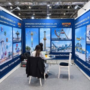HOTFUN park rides exhibition booth showcasing ferris wheel, pendulum ride, and major amusement park equipment banners