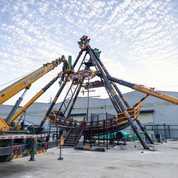 Heavy mobile cranes assembling A-frame steel support structure for pirate ship ride