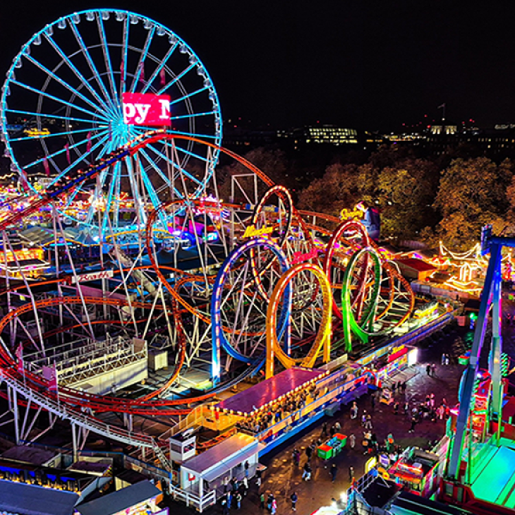 Small amusement park with roller coaster and Ferris wheel rides